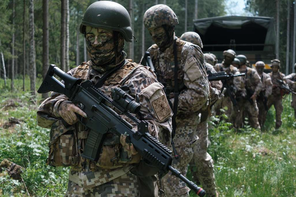Soldiers with the Latvian Zemessardze prepare to move out during a small-unit tactics exercise near Iecava on 7 June 2020. The Zemessardze are an all-volunteer force charged with protecting the Latvian homeland, and some units are mentored by US Army Special Forces soldiers. (U.S. Navy photo by LT Rob Kunzig/Released)