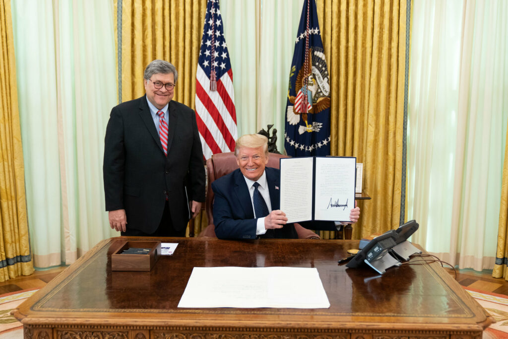 President Donald J. Trump, joined by United States Attorney General William Barr, displays his signature after signing an Executive Order on Preventing Online Censorship Thursday, May 28, 2020, in the Oval Office of the White House. (Official White House Photo by Shealah Craighead)